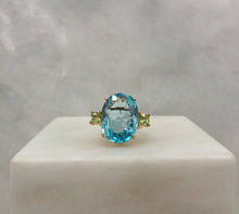 Oval Blue Topaz with princess cut Peridot sidestones Cocktail Ring